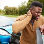 young-black-man-holding-neck-in-pain-after-a-car-accident